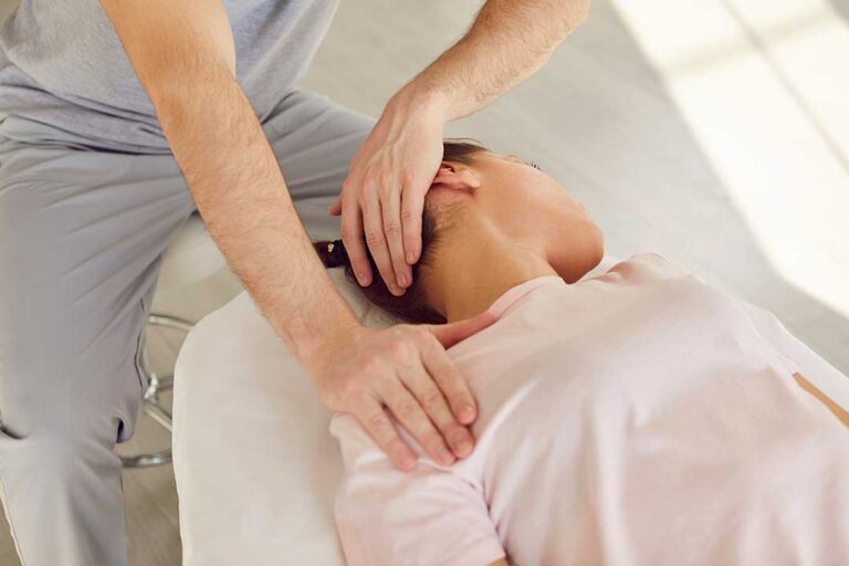 A chiropractor discussing treatment options with a patient in a quiet medical office.